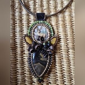 Artisan-crafted beaded pendant necklace with a deer motif